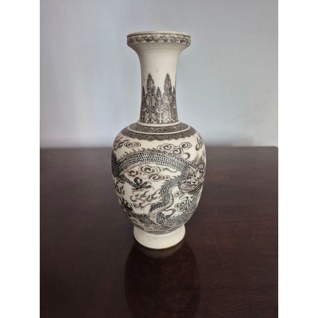 This antique Chinese vase is crafted from biscuit porcelain, which is unglazed. The technique offers a matte texture...