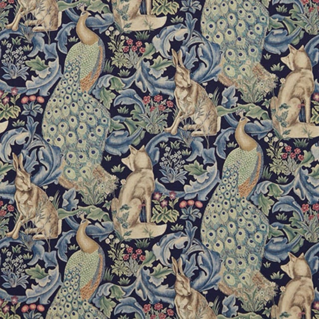 This printed fabric depicts scrolling acanthus leaves peacocks hares and foxes amongst bunches of wild flowers inspired by...