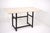 Table in black lacquered tubular metal and polished travertine top, 80s design.