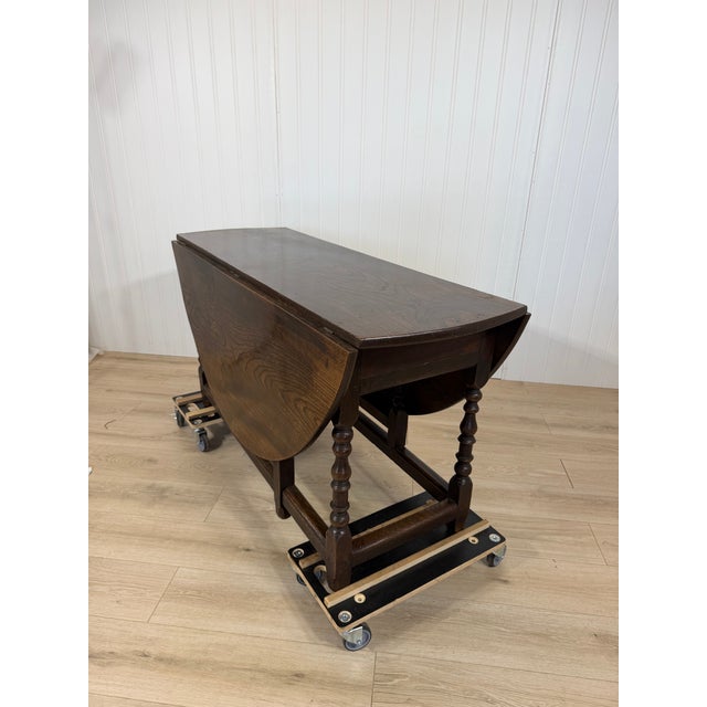 This finely crafted antique gateleg table is constructed of solid English oak with a rich, deep patina developed over...