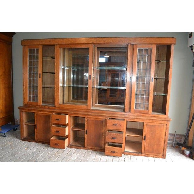20th-century Dutch oak display cabinet, shop cabinet, china cabinet, bookcase, or library cabinet. The height is 217 cm....