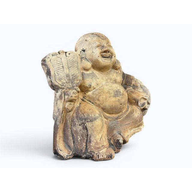 An earthenware Japanese Hotei, or lauhing buddha. This appears to be from the Mejii period (1868-1912). The height is 8",...