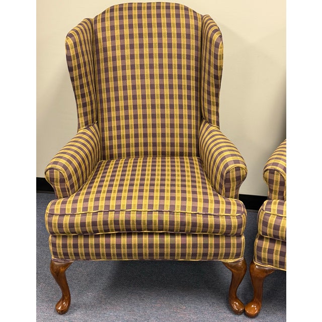 Beautiful traditional chairs upholstered in a handsome plaid pattern. Features a classic wingback style, loose seat...