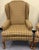 Beautiful traditional chairs upholstered in a handsome plaid pattern. Features a classic wingback style, loose seat...