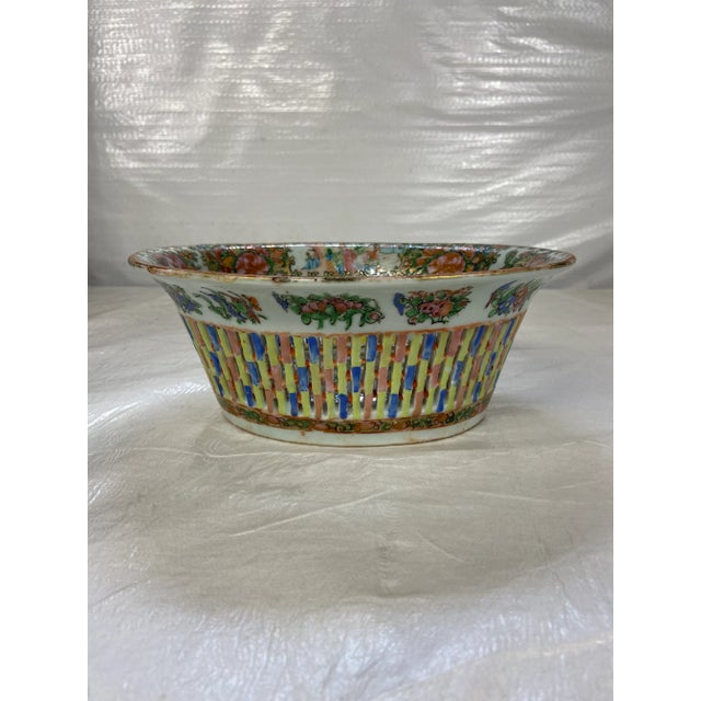 Antique Chinese porcelain reticulated or pierced oval shaped bowl with multicolored rose medallion decoration.