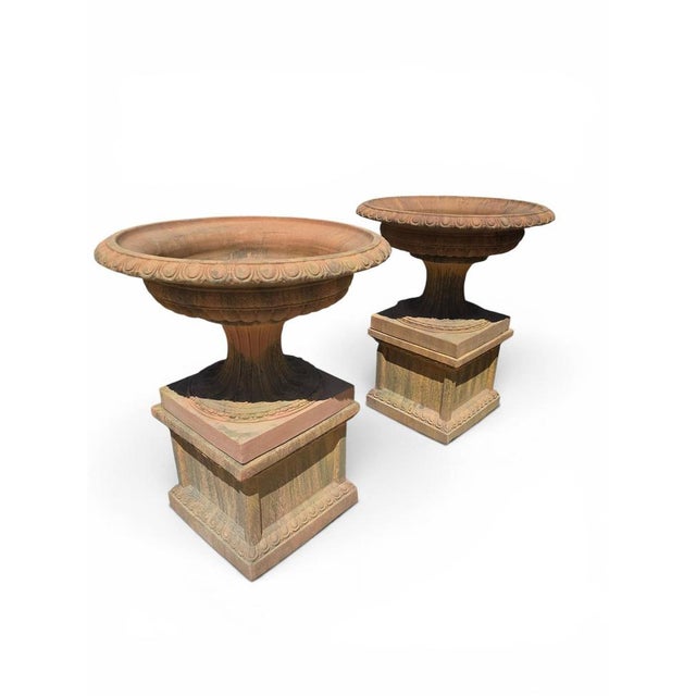 Impressive pair of monumental terracotta kraters inspired by the great ceremonial vessels of Ancient Greece. Crafted...