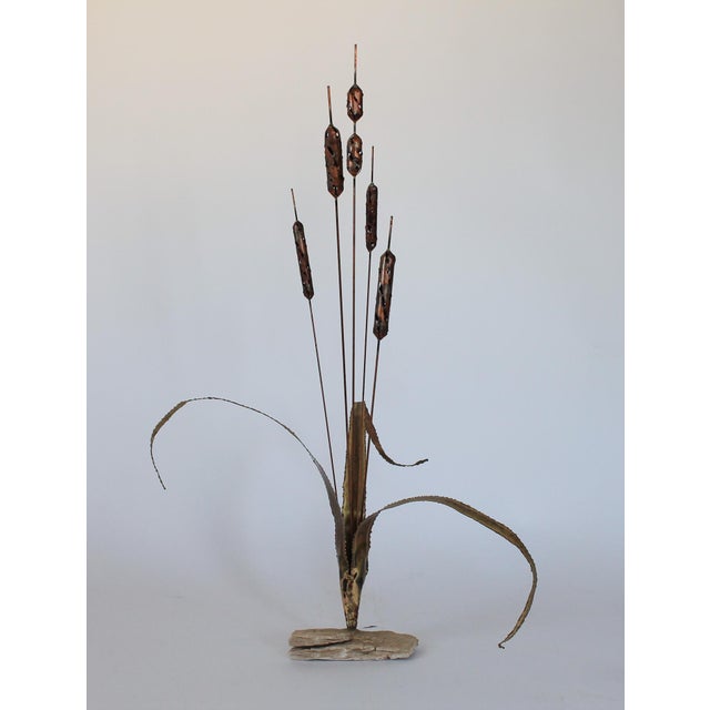 Vintage brutalist brass cattails with rock base decor. No makers mark. Patina and age wear to brass leaves.
