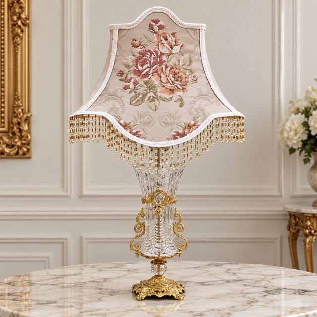 Charming French-style crystal table lamp featuring a soft blush pink shade and an exceptionally romantic silhouette...
