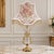 Charming French-style crystal table lamp featuring a soft blush pink shade and an exceptionally romantic silhouette...