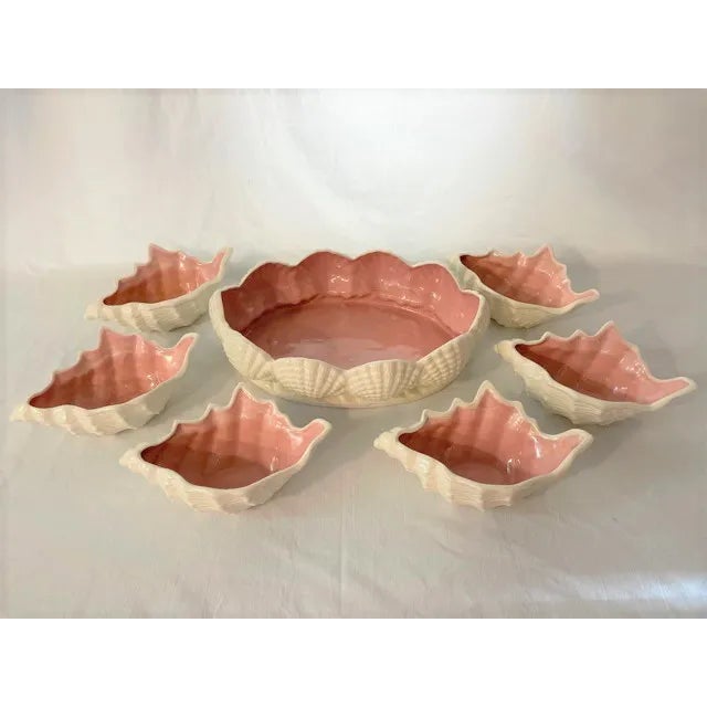 Darling set of Coastal style glazed pink and white bowls. One white serving bowl surrounded by shells and a pink center;...