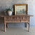 This charming vintage elm wood console is a one-of-a-kind piece with beautiful age and patina that adds character to any...