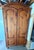 Traditional double-door solid pine armoire with classic arched bonnet top, raised panel doors and curved detailing. Warm...
