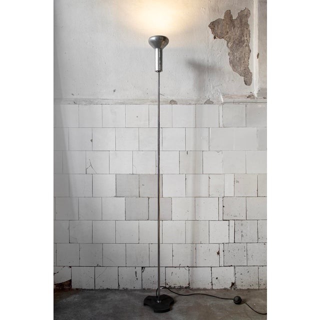 Floor lamp with metal frame, anodized aluminum reflector, and cast iron base. Model 1073 Designer Gino Sarfatti...