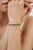 This elegant Art Deco-style tennis bracelet features 10.19 carats of oval-cut natural emeralds, carefully arranged in a...