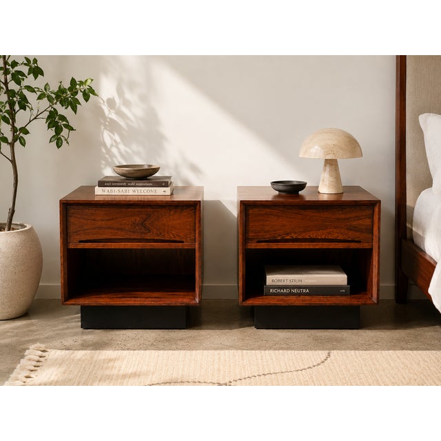 A striking pair of vintage Danish Modern nightstands by Dyrlund, crafted in Denmark and showcasing the clean architectural...
