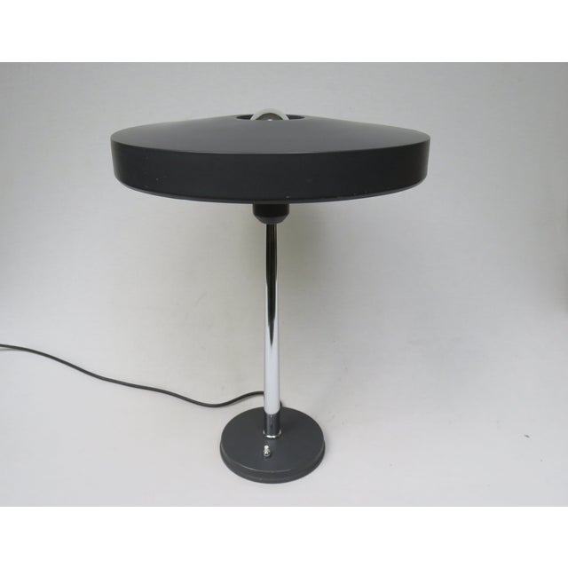 A minimalist yet elegant mushroom-shaped table lamp, manufactured in the 1960s by philips, designed by louis kalff. The...
