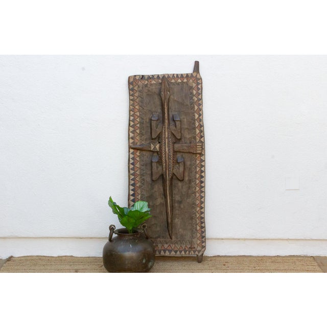 This 56.5-inch door (67.5 inches including its upper pivot finial) is a monumental single-slab piece from the Dogon or...