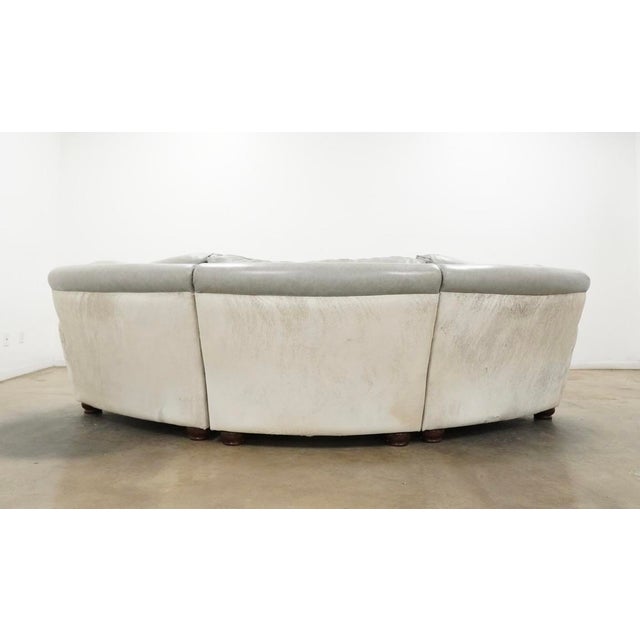Custom-made Italian curved conversation sofa featuring an elegant sculptural silhouette upholstered in soft gray leather...