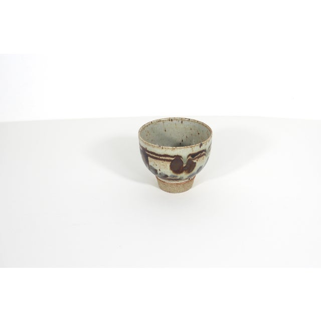 Vintage small pottery bowl or cup, signed by the artist on the bottom. Speckled stoneware with a beautiful organic...