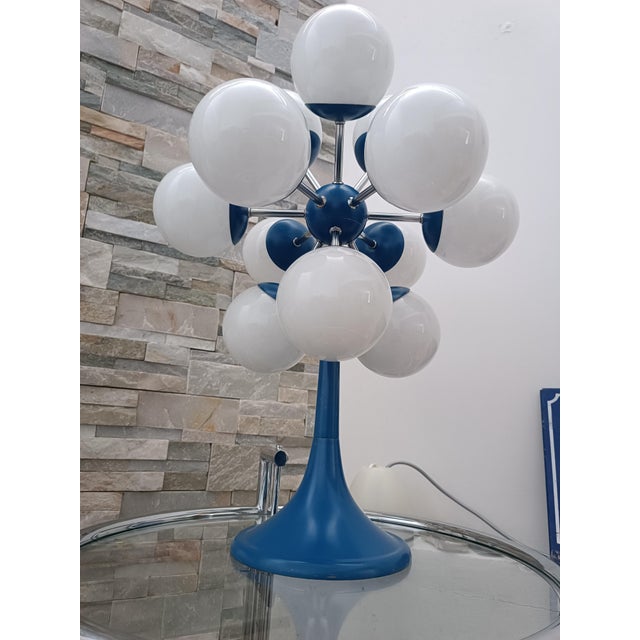 Magnificent Sputnik Space Age table lamp. 1970s. Blue lacquered metal frame. At the center is a metal sphere resembling an...