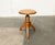 Mid-Century Dreieburzen. Simple stool with synthetic leather cover. The complex connections of the solid wood elements are...