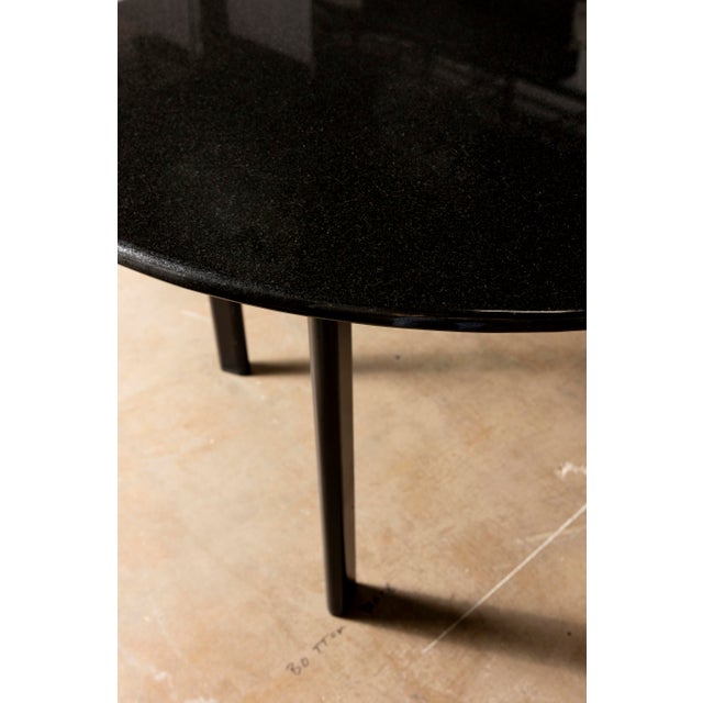 Elegant Knoll black granite table featuring a sleek, minimalist design that complements both modern and classic interiors....