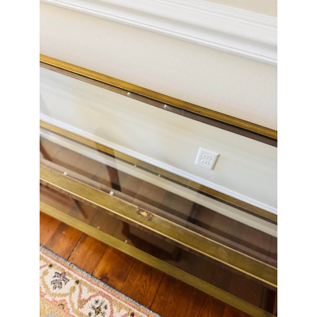 Stunning vintage aged brass two tier console table. Possibly a Mastercraft table. It has beautiful details along the sides...