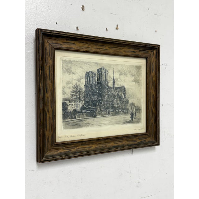 Design Plus Gallery presents "Paris - Nôtre Dame Les Quais" by Louis Marie Joseph Ridel. The etching shows off the Notre...