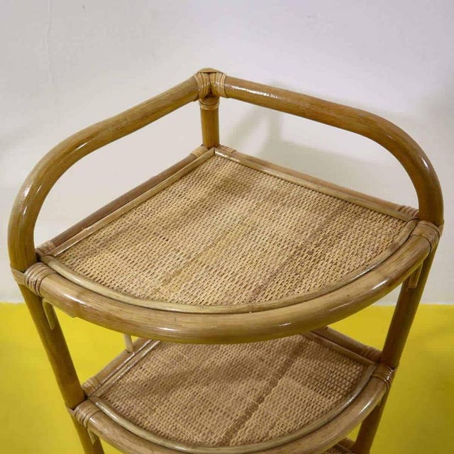 Bamboo and rattan corner shelf with three shelves.