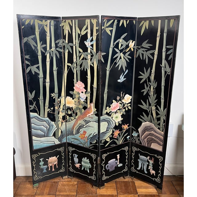 This beautiful Chinese screen is made up of four lacquered panels decorated with birds and bamboo. It is a Chinese work....