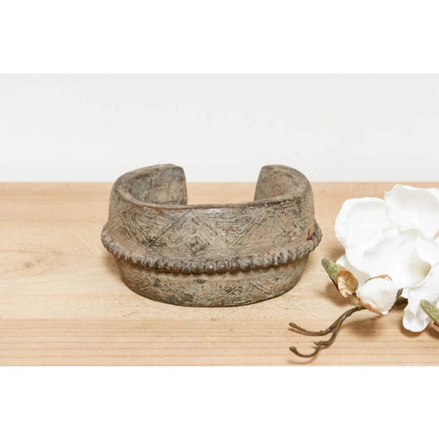 A powerful symbol of history and culture, this antique ceremonial bracelet whispers stories of Nigeria's Vere people in...