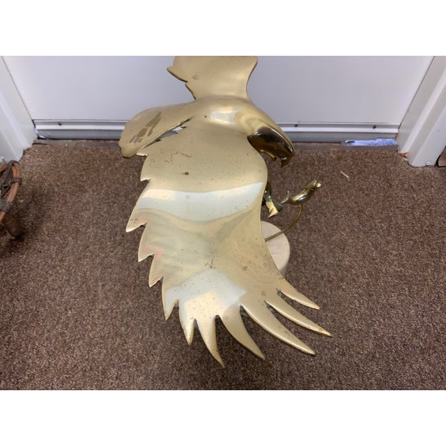 Vintage Bijan solid brass sculpture, features an eagle swooping down to catch a fish, removable top sits into a marble...