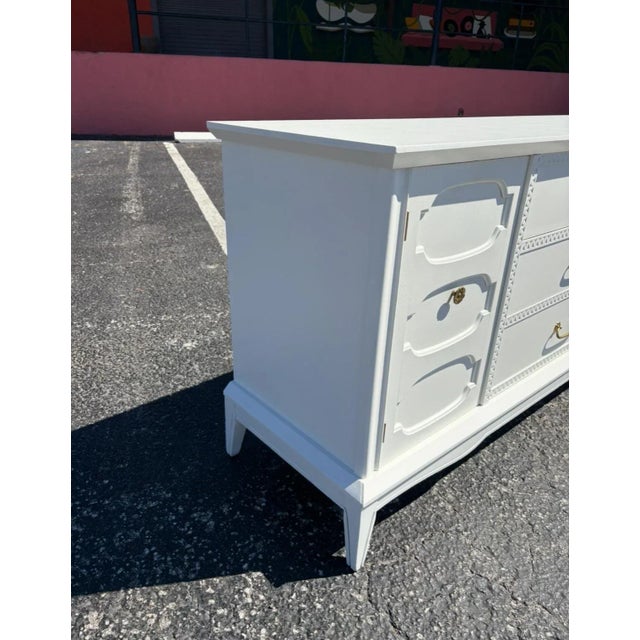 This niner is unmarked, but has similar elements to the Thomasville Horizon series. Two doors conceal a bank of 3 drawers...