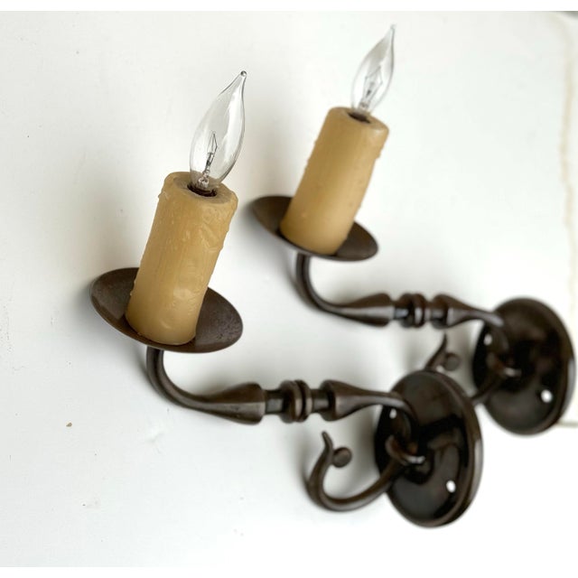 Beautifully made pair of vintage brass wall sconces with natural wax faux-candles, electrified for candelabra bulbs and...