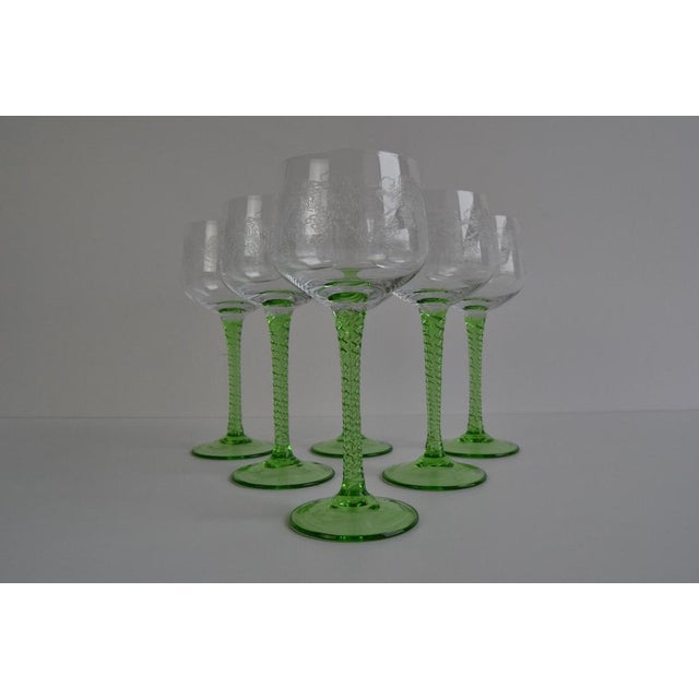 A set of six wine glasses on a green twisted stem, the top of the glass features a vine plant. Made in Czechoslovakia in...