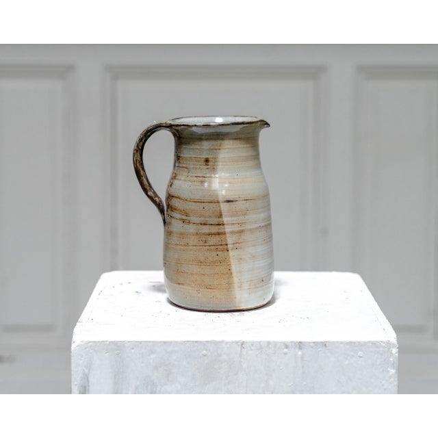 A lovely ceramic pitcher by Dominique Pouchain, dating from the 1960s. Its simple yet generous shape is enhanced by a...