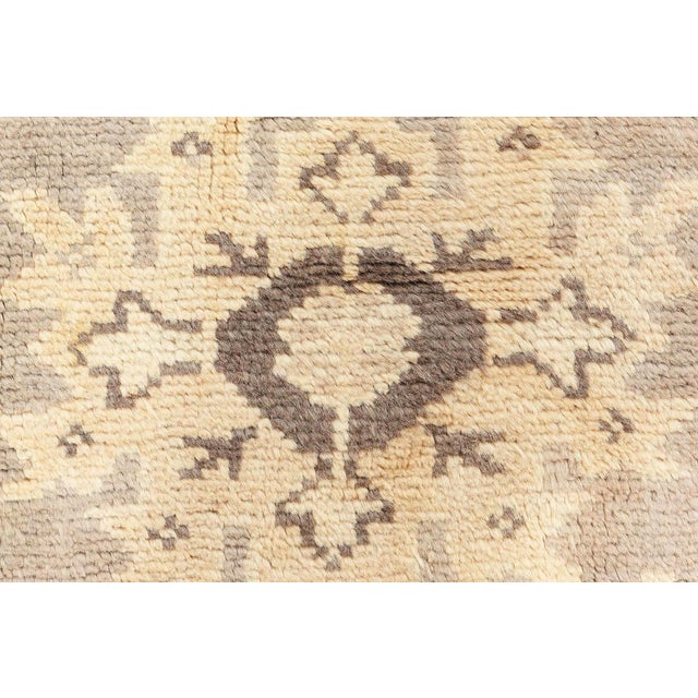 Emanating refined elegance and timeless artistry, this antique Turkish Oushak rug from the 1920s exemplifies the subtle...