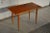 This coffee/side table was crafted in Sweden during the 1950's from solid teak wood. This simple streamlined design...