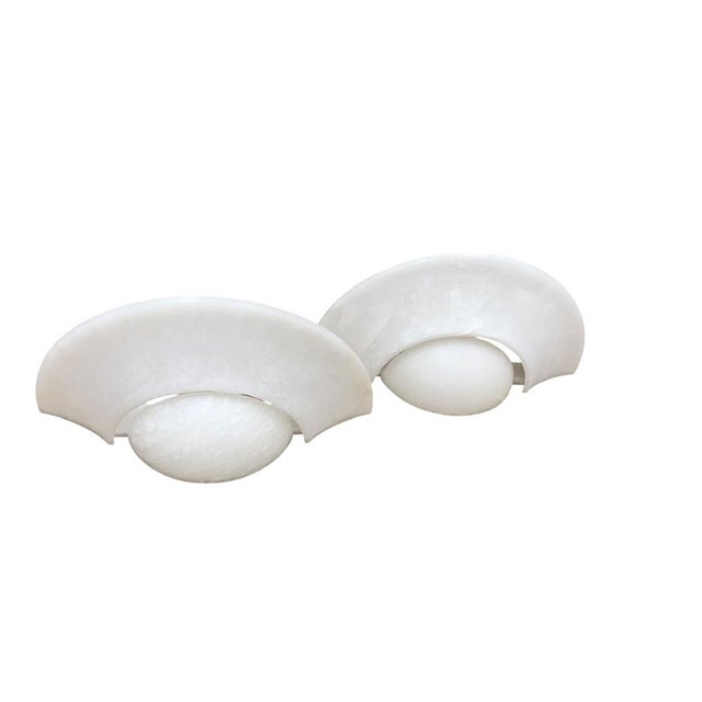 This stylish and chic crescent-shaped set is made of natural white alabaster and have a large size. The lamps have a...