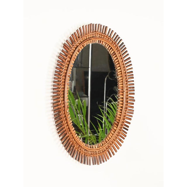 Marvelous French Riviera style oval mirror in bamboo, curved rattan and hand-woven wicker. This elegant and unique organic...