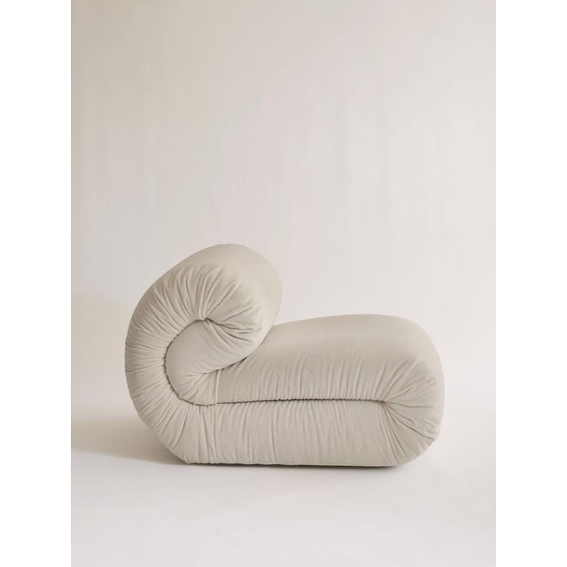 The riccio armchair stands out for its soft, enveloping design, defined by rounded shapes that evoke a cushion folded onto...