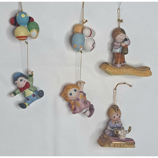 A charming and increasingly hard-to-find set of four Disney Goebel It's a Small World hand-painted ceramic ornament...