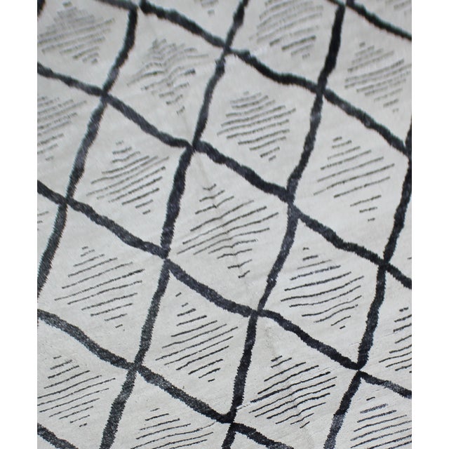 A beautiful handmade environmentally friendly Bamboo and silk rug, with a geometric design is made of 75% bamboo silk and...