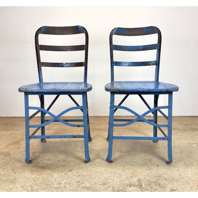 A fantastic and rare pair of early (1920’s to 1940’s) steel and oak industrial chairs by Angle Steel Stool Company and...