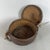 A rare and evocative nomadic storage basket with a lid and leather ties, attributed to traditional African craftsmanship...
