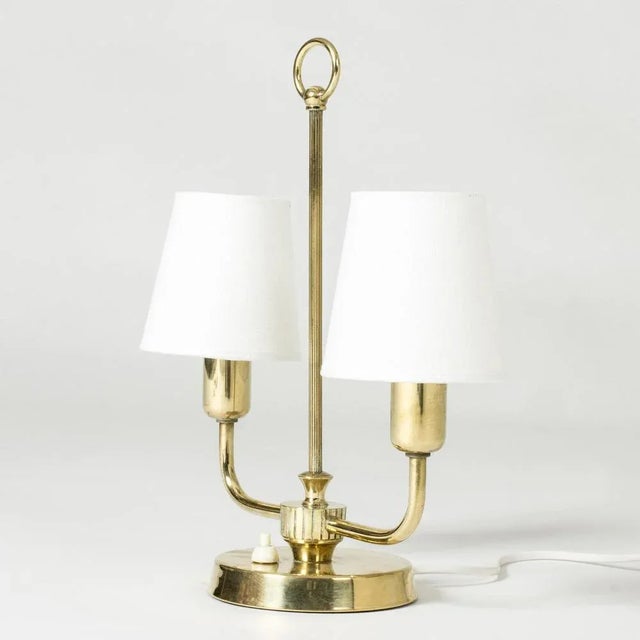 Lovely table lamp from Uppsala Armaturfabrik, made from brass. Neat size with decorative embossed stripes and a hoop at...