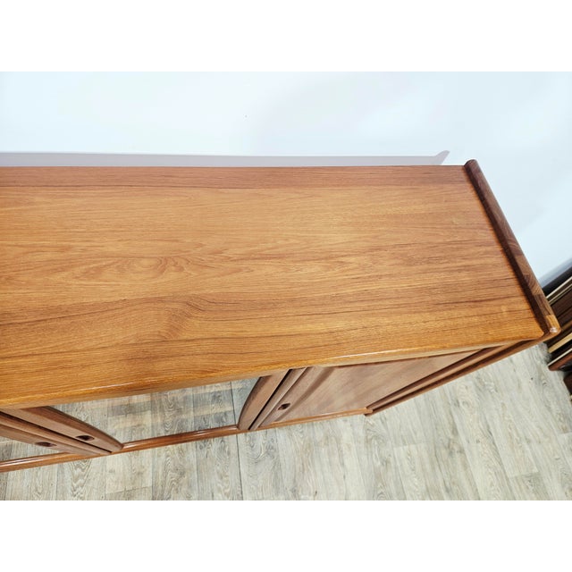 An exclusive, large sideboard with a glazed front, designed and manufactured by the renowned Danish firm Dyrlund in the...