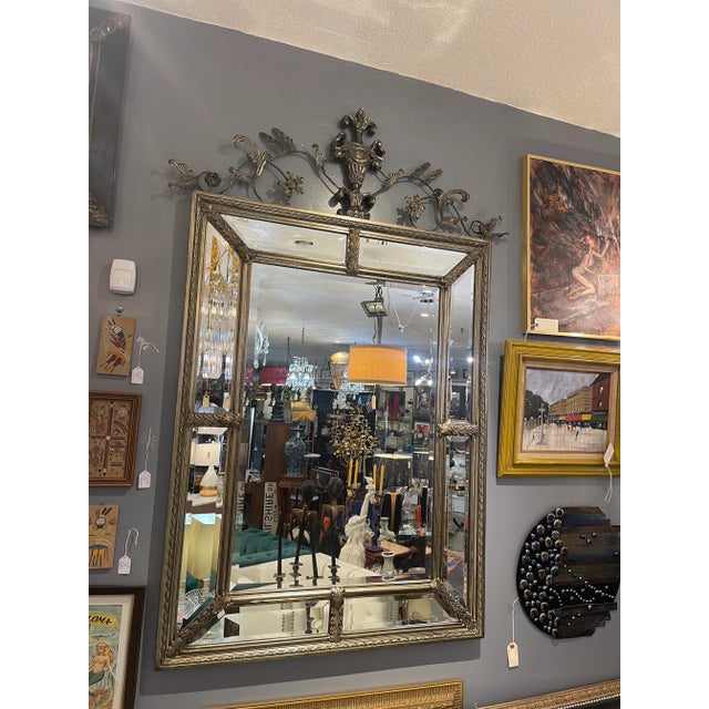 Transform your space with timeless elegance using the Uttermost Brushed Metal Neoclassical Monumental Mirror. This...