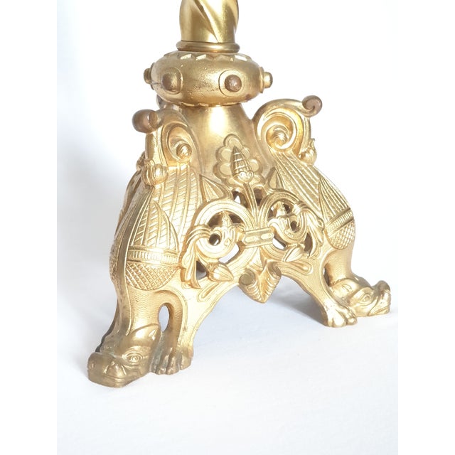 Pair of Neo-Gothic candelabra. In late 19th-century gilt bronze. Decorated with a chymere motif, cascading foliage and...