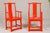 "The Lava Chair", a pair of Qing Dynasty period Yoke back armchairs from the 19th century, boldly re-lacquered in a burnt...